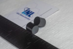 In early 2023, INL researchers fabricated roughly two dozen pellets of uranium dioxide (UO2) high-assay low-enriched uranium at the lab’s Experimental Fuels Facility at the Material and Fuels Complex. “These HALEU uranium dioxide fuel pellets are about the size of a gummy bear, seen here next to an INL business card,” the lab noted. Source: INL