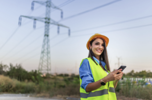 Woman working in field near transmission lines